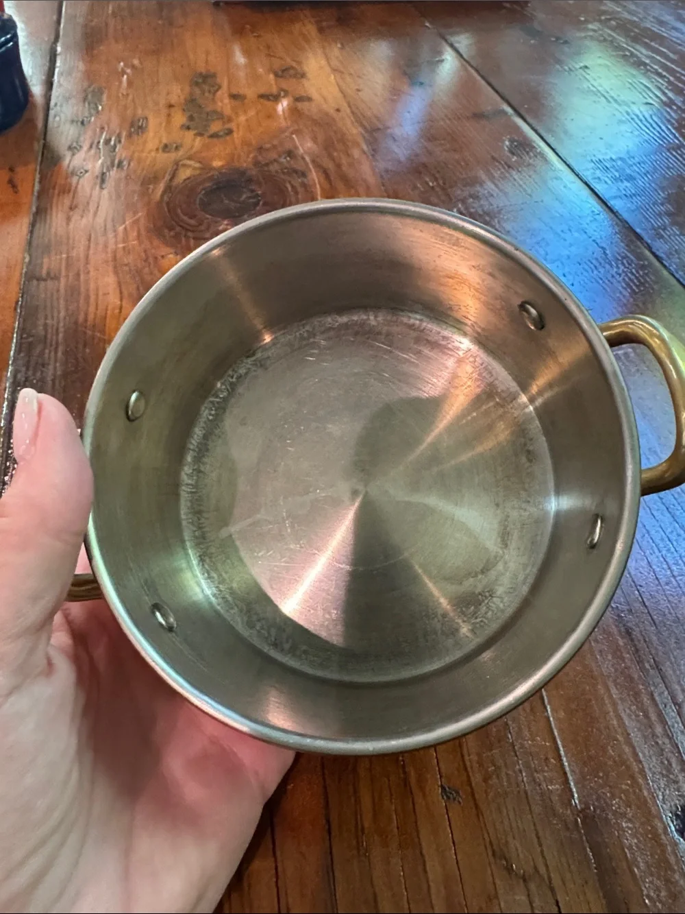 Two small copper pots with brass handles